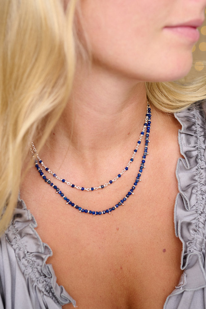 Boho Betty Salus Sodalite Silver Necklace featuring deep blue sodalite stones with sleek silver-plated accents and an adjustable design, perfect for adding a touch of serene elegance to any outfit.