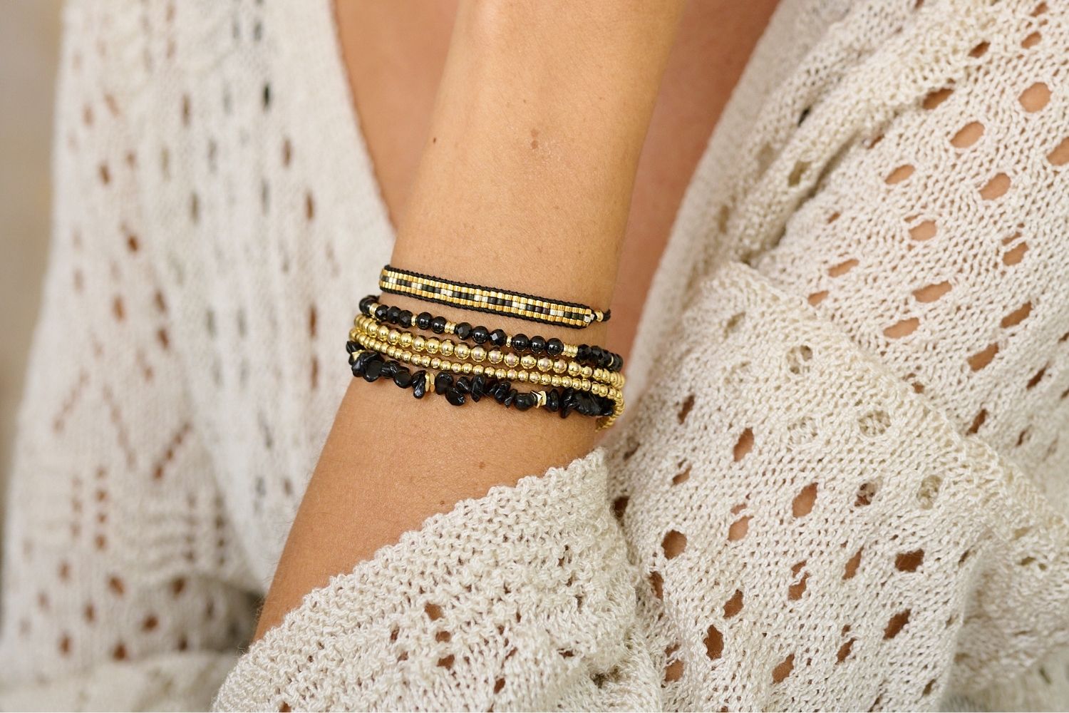 Boho Betty Sana in Black Spinel stacked with the complimentary Starshine Black, Wonder Black Spinel with Gleamed Gold Sable Minor Gold Nugget Bracelet Stack. Perfect for winter wardrobe styling. 