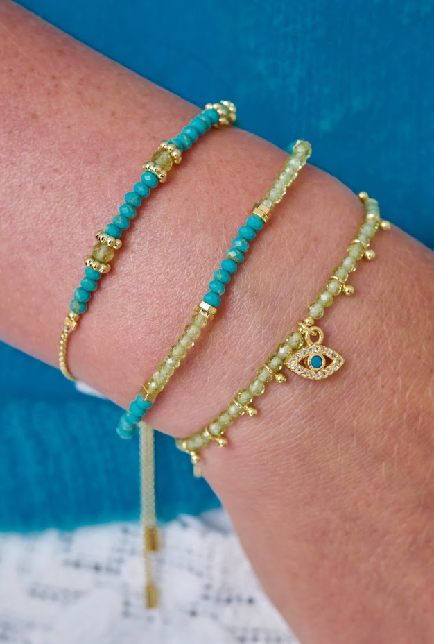 Bimini Peridot and Turquoise Gold Stacking Bracelet styled on the wrist, showcasing bright green peridot and turquoise beads with golden details for a tropical look.