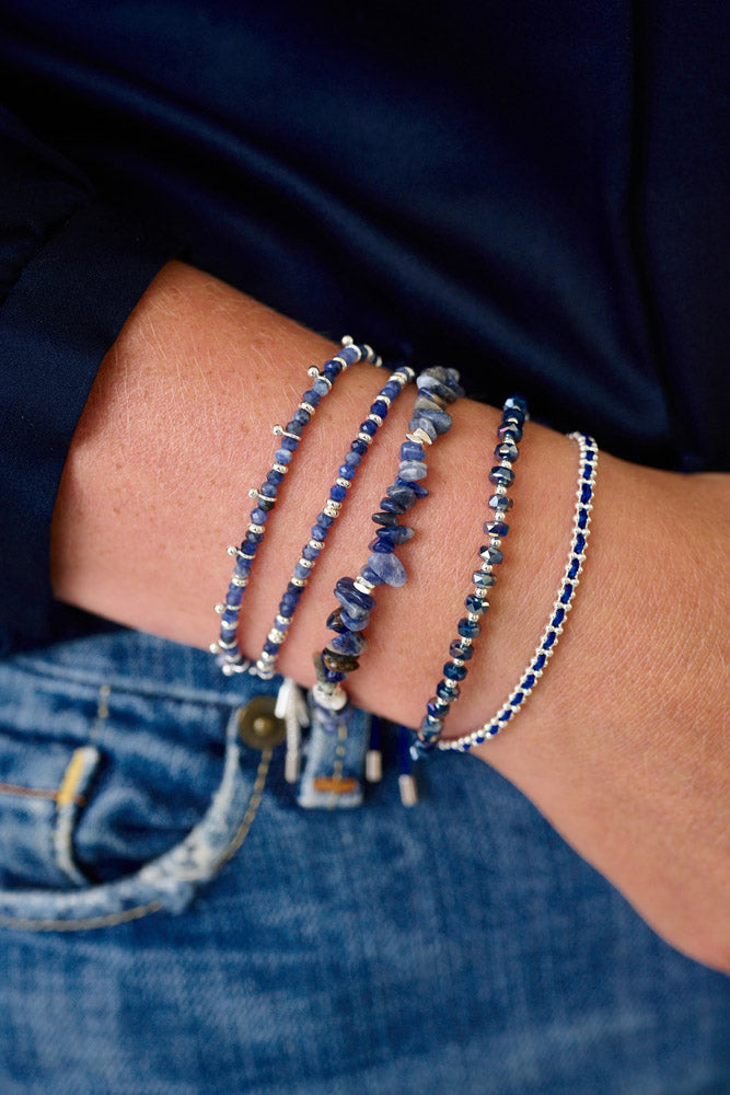 Kadavu Denim Sodalite & Silver Bracelet Stack styled on the wrist, showcasing deep blue Sodalite gemstones, silver accents, and a navy braided cord for a relaxed, boho-chic style.