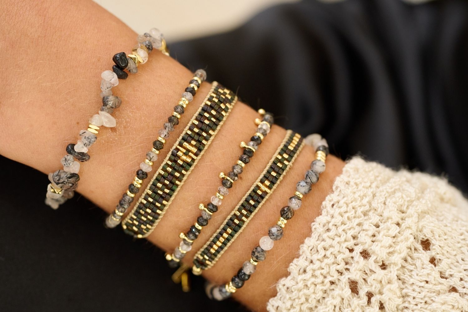 Maya Gold & Black Beaded Friendship Bracelet styled on the wrist, showcasing glossy black beads and warm gold accents, perfect for a glamorous night out.