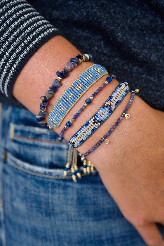 Viti Blue Denim Sodalite Gold Beaded Bracelet Stack styled on the wrist, showcasing vibrant blue Sodalite gemstones and shimmering gold accents for an ocean-inspired, boho-chic look.